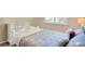 Comfortable bedroom features floral wallpaper accent wall and a white, decorative bedframe at 8321 Bryce Canyon Ave, Windermere, FL 34786