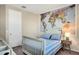 Charming bedroom with a map accent wall, large window, and blue and white bedding at 8321 Bryce Canyon Ave, Windermere, FL 34786