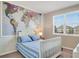 Charming bedroom with a map accent wall, large window, and blue and white bedding at 8321 Bryce Canyon Ave, Windermere, FL 34786