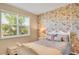 Comfortable bedroom features floral wallpaper accent wall and a white, decorative bedframe at 8321 Bryce Canyon Ave, Windermere, FL 34786
