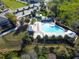 Birds eye view of the community pool, surrounded by manicured landscaping and trees at 8321 Bryce Canyon Ave, Windermere, FL 34786