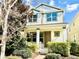 Charming two-story home featuring a manicured lawn and inviting front porch with a beautiful landscape at 8321 Bryce Canyon Ave, Windermere, FL 34786