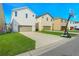 A row of modern two-story homes with attached garages and well-manicured lawns on a sunny day at 8321 Bryce Canyon Ave, Windermere, FL 34786