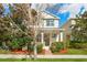 Charming two-story home with a manicured lawn and cozy front porch, complemented by lush landscaping at 8321 Bryce Canyon Ave, Windermere, FL 34786