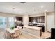 Spacious kitchen featuring dark wood cabinets, a center island, stainless steel appliances, and an adjacent dining area at 8321 Bryce Canyon Ave, Windermere, FL 34786