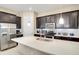 Modern kitchen with stainless steel appliances, white countertops, dark cabinets, and kitchen island at 8321 Bryce Canyon Ave, Windermere, FL 34786