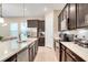 Modern kitchen with dark wood cabinetry, stainless steel appliances, a spacious island, and open to the living area at 8321 Bryce Canyon Ave, Windermere, FL 34786