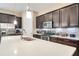Modern kitchen with stainless steel appliances, white countertops, dark cabinets, and kitchen island at 8321 Bryce Canyon Ave, Windermere, FL 34786