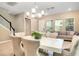 Open-concept living and dining area with abundant natural light, modern chandelier, and tile flooring at 8321 Bryce Canyon Ave, Windermere, FL 34786