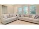 Cozy living room featuring neutral-toned sofas, decorative pillows, and plenty of natural light at 8321 Bryce Canyon Ave, Windermere, FL 34786