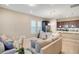 Open-concept living space with a neutral sofa, dining area, and kitchen with dark cabinets and stainless steel appliances at 8321 Bryce Canyon Ave, Windermere, FL 34786