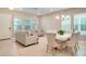 Open-concept living and dining area featuring tile floors, neutral color palette, and ample natural light at 8321 Bryce Canyon Ave, Windermere, FL 34786