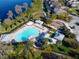 Aerial view of a community pool with ample seating and shaded areas, alongside a playground at 8321 Bryce Canyon Ave, Windermere, FL 34786