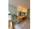 Bathroom featuring a double vanity, tile floors, a soaking tub and natural light at 8630 Knottingham Dr, Kissimmee, FL 34747