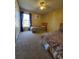 Bright bedroom featuring carpet floors, a ceiling fan, and two twin beds at 8630 Knottingham Dr, Kissimmee, FL 34747