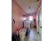 A small laundry room features a washer, dryer and storage shelving at 8630 Knottingham Dr, Kissimmee, FL 34747