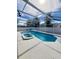 Relax in this stunning screened-in swimming pool and spa at 8630 Knottingham Dr, Kissimmee, FL 34747