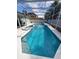 Enjoy the outdoors with this stunning screened-in swimming pool and spa at 8630 Knottingham Dr, Kissimmee, FL 34747