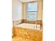 Bathroom with garden tub, tile surround, and window at 8923 Azalea Sands Ln, Davenport, FL 33896