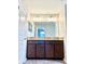 Bathroom featuring double sink vanity with granite countertop and dark wood cabinets at 8923 Azalea Sands Ln, Davenport, FL 33896