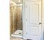 Bathroom featuring tiled shower with glass door, enhancing the home's modern appeal at 8923 Azalea Sands Ln, Davenport, FL 33896