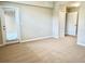 Carpeted bedroom featuring a door to the outside and closet at 8923 Azalea Sands Ln, Davenport, FL 33896