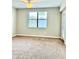 Bright bedroom with carpet flooring, ceiling fan, large window and access to the balcony at 8923 Azalea Sands Ln, Davenport, FL 33896