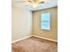 Cozy bedroom with neutral paint, carpet, and a window providing natural light at 8923 Azalea Sands Ln, Davenport, FL 33896