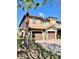 Two-story townhome with a 2-car garage, landscaped yard, and a brick driveway at 8923 Azalea Sands Ln, Davenport, FL 33896