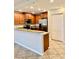 Kitchen with granite countertops, wood cabinets, and stainless steel appliances at 8923 Azalea Sands Ln, Davenport, FL 33896