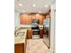 Beautiful kitchen featuring granite countertops, stainless steel appliances, and wood cabinetry at 8923 Azalea Sands Ln, Davenport, FL 33896