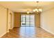 Spacious living room with tile flooring, large sliding glass doors, and chandelier at 8923 Azalea Sands Ln, Davenport, FL 33896