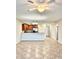 Open floor plan with tile floors connecting the living area and kitchen at 8923 Azalea Sands Ln, Davenport, FL 33896