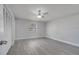 This bedroom features a ceiling fan, a window and a closet with modern gray flooring at 8960 Se 88Th Pl, Ocala, FL 34472