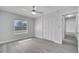 This bedroom features a ceiling fan, a window and a closet with modern gray flooring at 8960 Se 88Th Pl, Ocala, FL 34472