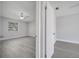 Open doorway showing a well-lit bedroom with modern design and easy access to the bathroom at 8960 Se 88Th Pl, Ocala, FL 34472