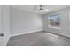Airy bedroom showcasing vinyl flooring, a ceiling fan, and a bright window at 8960 Se 88Th Pl, Ocala, FL 34472