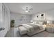 Cozy bedroom features a ceiling fan, stylish gray walls and elegant decorative wall art at 8960 Se 88Th Pl, Ocala, FL 34472