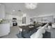 Modern dining room with a long table, seating for eight, and stylish lighting fixtures at 8960 Se 88Th Pl, Ocala, FL 34472