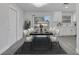 Modern dining room with a long table, seating for eight, and stylish lighting fixtures at 8960 Se 88Th Pl, Ocala, FL 34472