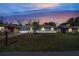 Charming single-story home featuring a well-maintained lawn at dusk under a colorful sky at 8960 Se 88Th Pl, Ocala, FL 34472