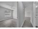 Hallway leading to a sunlit bedroom and bathroom with consistent flooring throughout at 8960 Se 88Th Pl, Ocala, FL 34472