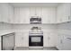 Modern kitchen features stainless steel appliances, white quartz countertops, and white cabinetry at 8960 Se 88Th Pl, Ocala, FL 34472
