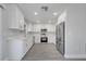 Modern kitchen features white cabinetry, stainless steel appliances, and luxury vinyl plank flooring at 8960 Se 88Th Pl, Ocala, FL 34472