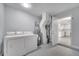 This is a laundry room that offers appliances and a doorway into a bright, white kitchen at 8960 Se 88Th Pl, Ocala, FL 34472