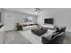 Bright living room with modern furnishings, a sleek coffee table, and plenty of natural light at 8960 Se 88Th Pl, Ocala, FL 34472