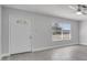 Bright living room features a white front door, a window with blinds, and luxury vinyl plank flooring at 8960 Se 88Th Pl, Ocala, FL 34472