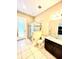 Modern bathroom with a glass-enclosed shower, granite countertops, and neutral color palette at 9207 Busaco Park Way, Winter Garden, FL 34787