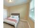 Cozy bedroom featuring a comfortable bed, soft lighting, and a window for natural light at 9207 Busaco Park Way, Winter Garden, FL 34787