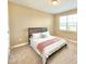 Cozy bedroom featuring neutral walls, carpet, and a window for natural light at 9207 Busaco Park Way, Winter Garden, FL 34787